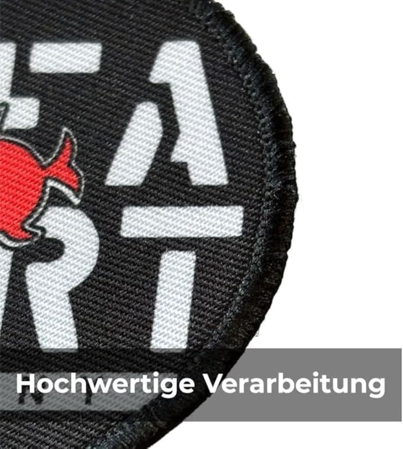 May include: A circular black patch with white lettering and a red graphic. The text includes the word "HEAT" and a number "1". The patch has a stitched border and the text "Hochwertige Verarbeitung" is visible at the bottom.
