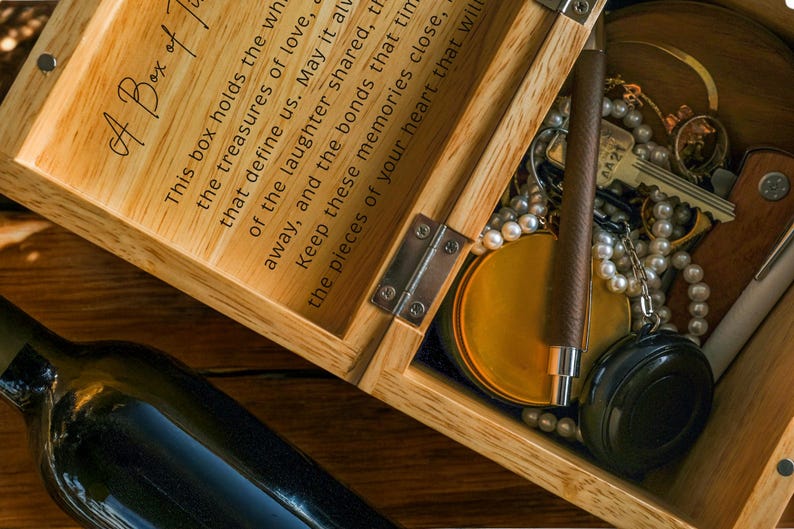 May include: A wooden box with a hinged lid, inscribed with the text "A Box of Treasures. This box holds the whispers of the treasures of love, that define us. May it always hold the laughter shared, the memories close, and the bonds that time cannot take away. Keep these memories close, the pieces of your heart that will always be with you."