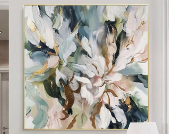 May include: Abstract painting with white, green, and gold floral shapes on a canvas with a gold frame. The painting is hanging on a white wall above a white dresser with gold hardware.