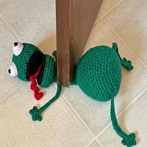 May include: A white ceramic mug with a black handle and the text "But First, Coffee" in a bold, black font. The mug is set against a neutral background, highlighting its simple design.