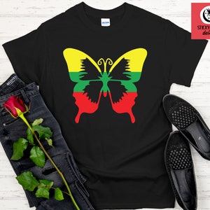 May include: Black t-shirt with a butterfly design featuring the colors of the Lithuanian flag: yellow, green, and red.