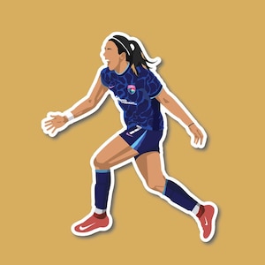 May include: A female soccer player wearing a blue and black jersey with a white and pink logo. She is running with her right leg forward and her left leg extended behind her. She is wearing blue socks and red and white cleats.