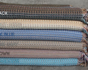 May include: Six different colors of woven fabric with fringe. The colors are black, light beige, sax blue, dark gray, brown, and turquoise.