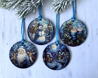 May include: Four round blue and white Christmas ornaments with different winter scenes. One ornament features a snowman, another has a Santa Claus with reindeer, another has a winter village, and the last one has candles and holly.