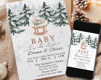 May include: A winter-themed baby shower invitation with a watercolor illustration of a baby crib in a snowy forest. The invitation reads "Baby It's Cold Outside Donna & Oliver" and includes the date, time, and location of the shower.
