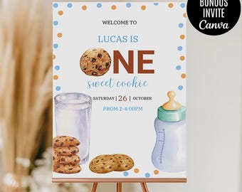 May include: A blue and white welcome sign with brown polka dots for a first birthday party. The sign says "Welcome to Lucas is One sweet cookie" and includes the date "Saturday | 26 | October" and the time "From 2-4:00PM". The sign also features a watercolor illustration of a glass of milk and a baby bottle, along with chocolate chip cookies.