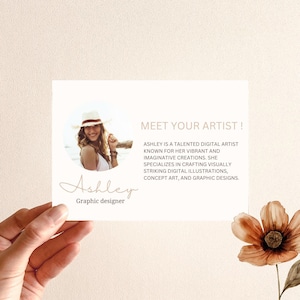 May include: A white card with a photo of a woman wearing a straw hat and a white top. The text on the card reads "Meet Your Artist! Ashley is a talented digital artist known for her vibrant and imaginative creations. She specializes in crafting visually striking digital illustrations, concept art, and graphic designs. Ashley Graphic designer"