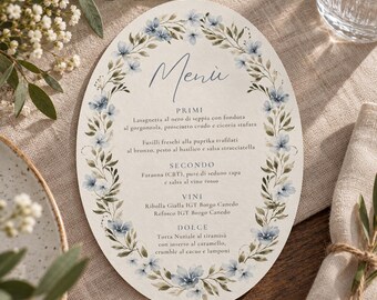 May include: An oval-shaped menu card featuring a watercolor floral border of light blue flowers and green leaves. The text reads Menù, PRIMI, SECONDO, VINI, and DOLCE, followed by Italian food and wine listings printed in a dark blue serif font.