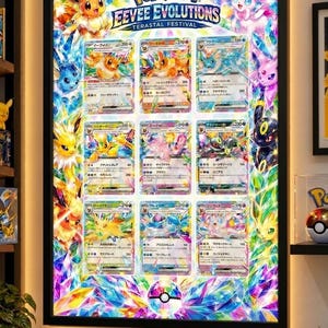 May include: A rectangular wall-mounted light box featuring a Pokémon Eevee Evolutions Terastal Festival poster. The display showcases nine individual trading cards arranged in a grid, surrounded by colorful crystalline graphics.