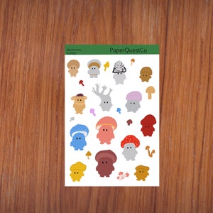 May include: A sheet of colourful mushroom stickers with various designs and colours. The stickers feature mushrooms with different hats, stems, and faces. The sheet is labelled "Mushrooms P27001" and "PaperQuestCo".