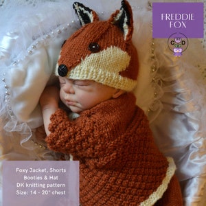 May include: A knitted fox hat and matching jacket, shorts, and booties for a baby. The outfit is brown with white accents and features a fox face on the hat. The pattern is for sizes 14-20 inches chest.