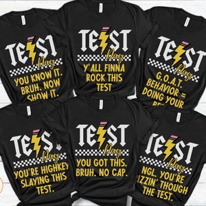 May include: Six black t-shirts with white text and a yellow lightning bolt graphic. The text on the shirts reads "Test Day" and includes phrases like "You know it.  Bruh. Now show it." and "Y'all finna rock this test."