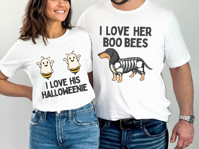 May include: Two white t-shirts with a Halloween-themed couple's design. The woman's shirt features two ghost bees with the text "I love his Halloweenie". The man's shirt features a dachshund with a skeleton design and the text "I love her Boo Bees".