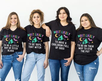 May include: Four people wearing black t-shirts with Halloween-themed graphics. Each shirt has the words "MOST LIKELY" above a unique phrase: "TO BE A LITTLE RAY OF PITCH BLACK", "TO BE 100% THAT WITCH", "TO HAVE A CAULDRON FULL OF SASS", and "TO BE ON THEIR WAY TO STIR THE POT".