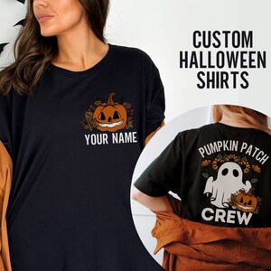 May include: Two black t-shirts with a Halloween theme. One shirt features a pumpkin with the text "Your Name" and the other shirt features a ghost with the text "Pumpkin Patch Crew".