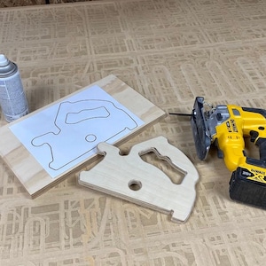 Downloadable PDF file for printing to legal size printer paper to cut out of wood a push stick in the shape of a circular saw for using on a table saw.