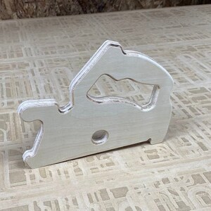 Downloadable PDF file for printing to legal size printer paper to cut out of wood a push stick in the shape of a circular saw for using on a table saw.