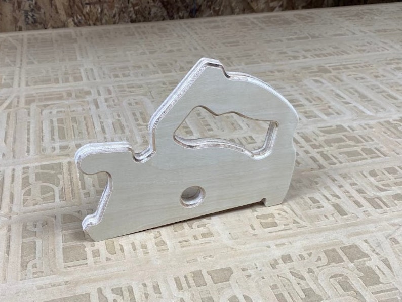 Downloadable PDF file for printing to legal size printer paper to cut out of wood a push stick in the shape of a circular saw for using on a table saw.
