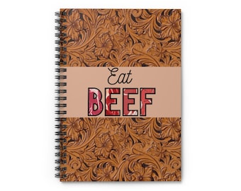 May include: A spiral-bound notebook with a brown, floral-patterned cover. The notebook features the words "Eat BEEF" in a bold, red and white font across the center. The design has a rustic, western aesthetic.
