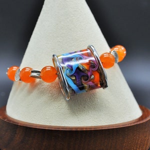 Unique glass lampwork bead accented with orange glass and sterling silver bracelet