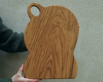 Wood chopping board with handle. Abstract art. Serving, charcuterie, cheese board.