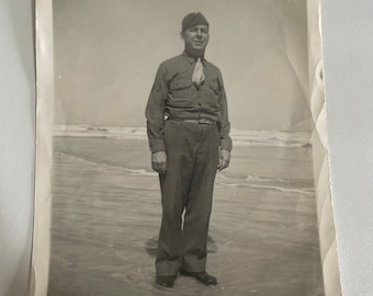 Photograph of man on beach, possibly Navy.
