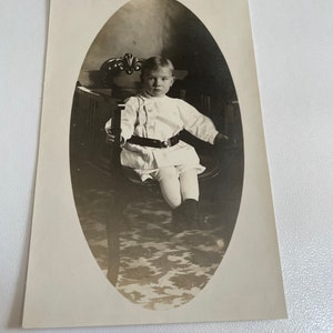 Late 1800’s to early 1900’s photo postcard of little boy strapped to chair