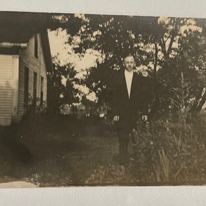 Early 1900&#39;s photo of man standing in front of house
