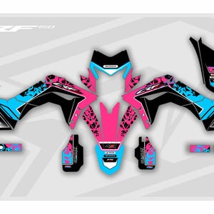 May include: A graphic design for a motorcycle, featuring a vibrant color scheme of black, pink, and blue. The design includes the text "CRF 150" and "012". The design is composed of multiple pieces.
