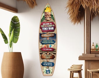 May include: A surfboard-shaped wall sign featuring a tiki mask graphic at the top and multiple wooden-style directional signs with text including Welcome to Tiff & Casey's Tiki Bar, It's Always 5:00 Here, Tiki Vibes Only, and Life is Better at the Tiki Bar.