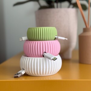 An example of the three sizes available stacked on top of each other with cables inserted.