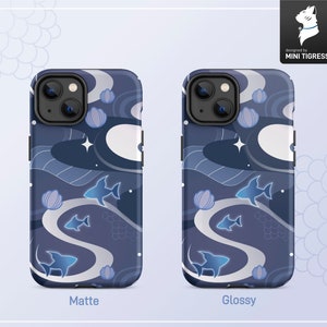 May include: Two phone cases with a blue and white abstract design featuring stylized fish and stars. The case on the left is labeled "Matte" and the case on the right is labeled "Glossy".