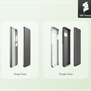 May include: Two phone cases, one a snap case and one a tough case, are shown in a mockup. The snap case is green with a white design. The tough case is black with a white design. Both cases are for a smartphone.