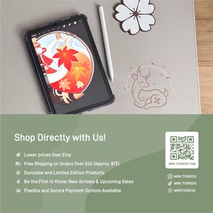 May include: A digital tablet with a black case displays a colorful illustration of a character with red and orange leaves. A white stylus and a decorative flower are next to the tablet. The image also includes the text "Shop Directly with Us!"