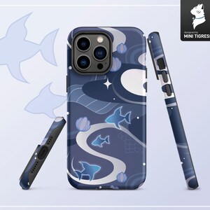 May include: A blue and white phone case with a design of fish and waves. The case has a black camera bump with three lenses. The text "designed by MINI TIGRESS" is printed on the case.