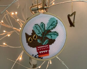 Shy cat hiding behind plant completed cross-stitch wall hanging art, ornament