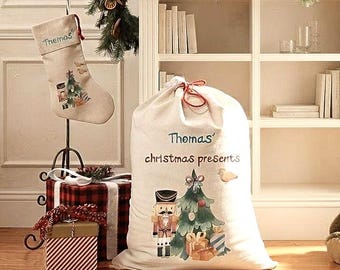 May include: A beige fabric Christmas stocking and a large matching drawstring gift sack. Both items feature the name Thomas, a nutcracker illustration, and a Christmas tree graphic. The sack is printed with the text Thomas' christmas presents.