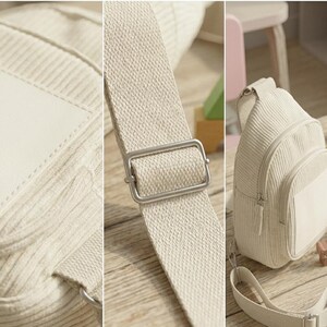 Puede incluir: Bolso bandolera de pana color crema con un bolsillo frontal y una correa ajustable. El bolso tiene una hebilla de metal plateado y un parche blanco en blanco. El bolso est&aacute; sobre una superficie de madera.