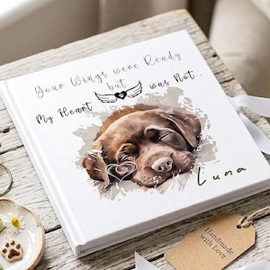 May include: A white square book with the text "Your Wings were Ready but My Heart was Not..." and a watercolor illustration of a sleeping brown dog. The dog's name, Luna, is written below. A tag reads "Handmade with Love."