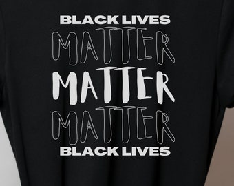 May include: Black t-shirt with the text "Black Lives Matter" repeated three times in white.