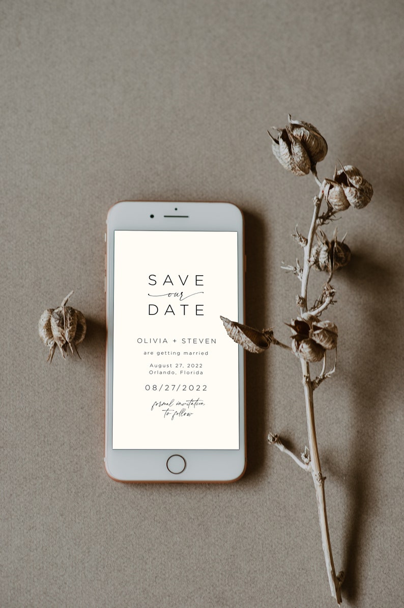May include: A smartphone screen displaying a save the date announcement for Olivia and Steven's wedding on August 27, 2022 in Orlando, Florida. The text reads "Save our Date" with a handwritten flourish under "our". The date is displayed as 08/27/2022 and the text "formal invitation to follow" is written in cursive.