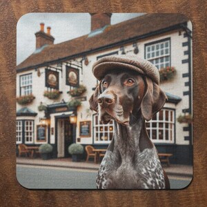 May include: A brown and white German Shorthaired Pointer dog wearing a brown tweed hat, standing in front of a white building with a sign that says "The Crown".