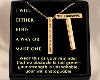 May include: Gold-colored bar pendant necklace with a chain, displayed in a black box. The pendant has the text "AUT VIAM INVENIAM AUT FACIAM" and "SIDE ENGRAVING". The box has the text "I WILL EITHER FIND A WAY OR MAKE ONE".