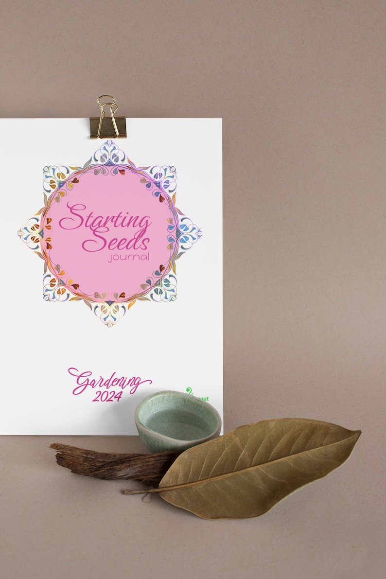 May include: A white journal with a pink circle and the text "Starting Seeds Journal" in a decorative font. The circle is surrounded by a colorful floral design. The text "Gardening 2024" is written in pink below the circle.