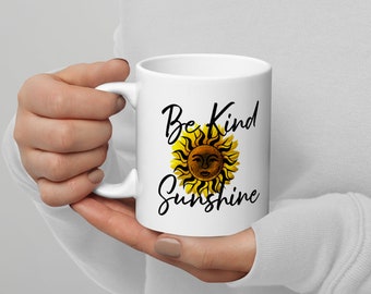 May include: White ceramic mug with a black and yellow sun graphic and the text "Be Kind Sunshine".