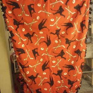 Hockey players on red print handmade fleece tie blanket
