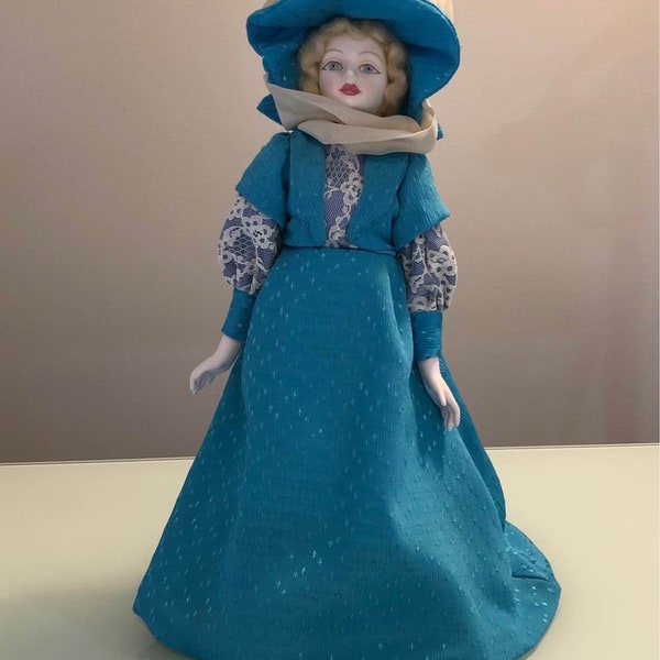 Limited Edition Royal Doulton “Nisbet” heirloom doll with stand, 1983, Henley regatta blue dress