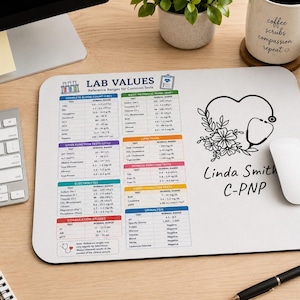 May include: A rectangular white mouse pad featuring a printed medical reference chart titled LAB VALUES with various test categories and ranges. To the right, a black line art graphic shows a heart-shaped stethoscope with flowers and the text Linda Smith C-PNP.