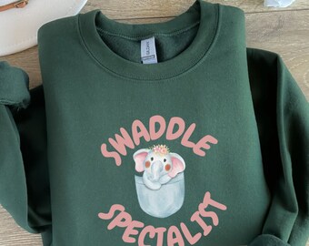 Labor and Delivery Nurse Shirt, L&D Nursing Shirt, OB Nurse T-Shirt, Swaddle Specialist, Postpartum Nurse, Mother Baby Nurse Shirt, Doula