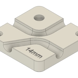 May include: A white plastic 3D printed cable management clip with a 14mm opening. The clip has four holes for mounting.